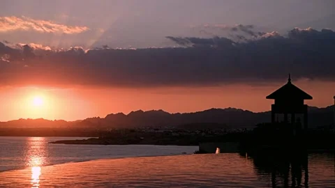 Sunset over the pool overlooking the sea Видео 331563967
