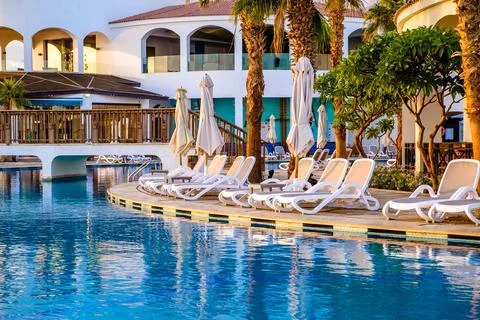 Sunset over the pool overlooking the sea Photos
