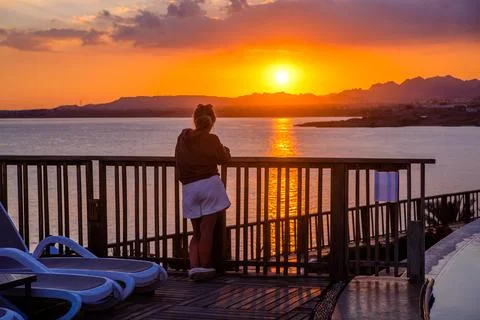 Sunset over the pool overlooking the sea Photos