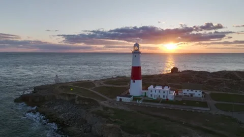 Sunset over Portland Bill Lighthouse, Portland, Isle of Portland, Dorset, UK Stock Footage 304458445
