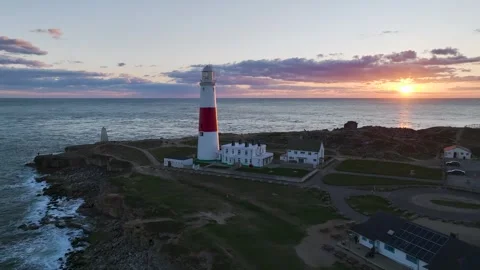 Sunset over Portland Bill Lighthouse, Portland, Isle of Portland, Dorset, UK Stock Footage 304458468