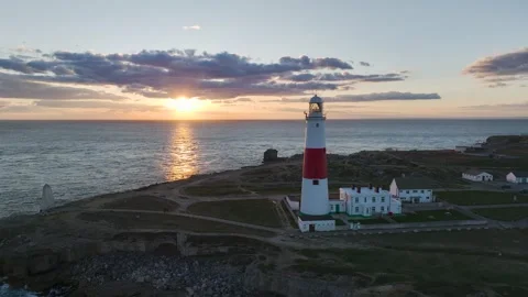 Sunset over Portland Bill Lighthouse, Portland Bill, Isle of Portland, Dorset Stock Footage 304819164