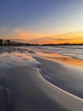 Sunset over the quiet beach Stock Photos
