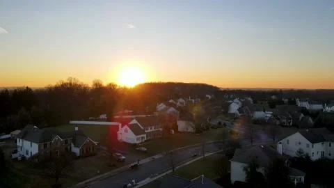 Sunset Over Quiet Suburban Town Flying Up Static moving Forward  Stock Footage 228700085