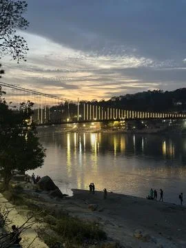 Sunset over Ram Jhula bridge in Rishikesh, India. Stock Photos