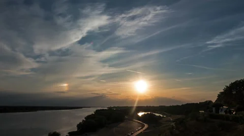 Sunset over the river and the phenomenon of iridescence in the sky Stock Footage 64575071