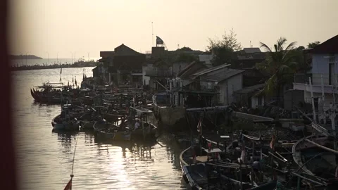 Sunset over the river and silhouette of a residential view Video stock 258313271