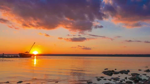 Sunset over the River with Boat in the Background Stock Footage 95688395