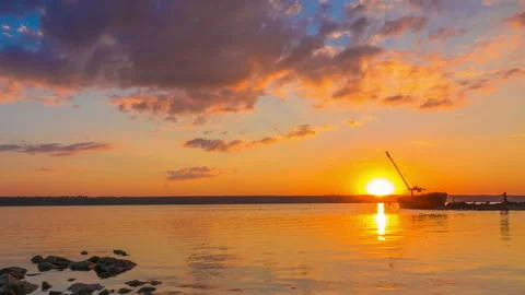 Sunset over the River with Boat in the Background Stock Footage 97199081