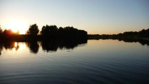 Sunset over the river, clear sky. Stock Photos