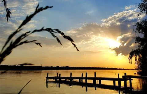 Sunset over the river in the clouds Stock Photos