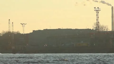 Sunset over river with factory smooking chimney across Stock Footage 10860889