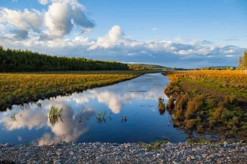 Sunset over river with fall trees. Sweden. Stock Photos