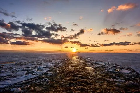 Sunset over the river in the ice Stock Photos