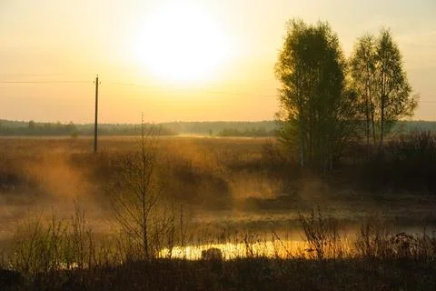 Sunset over the river in the mist. Early spring. Russia Stock Photos