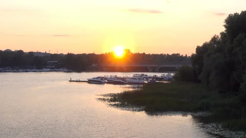 Sunset over the river with motor yachts at the pier. Stock Footage 236924822
