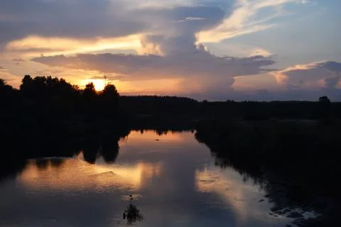 Sunset over the river. Stock Photos