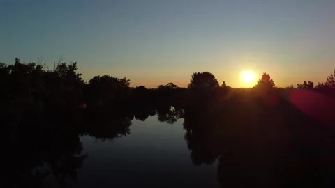 Sunset over the river at a quiet location in nature during evening hours Stock Footage 335333557