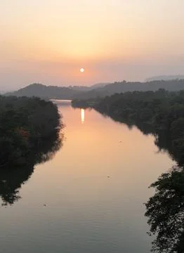 Sunset over river from sky  with sun reflection from sky Stock Photos