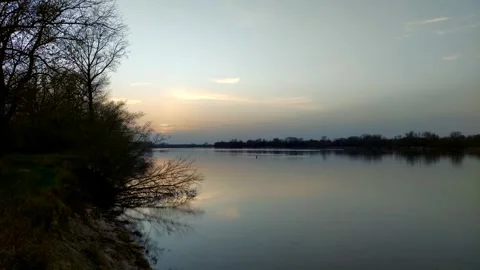 Sunset over a river in springtime. Video stock 271580326
