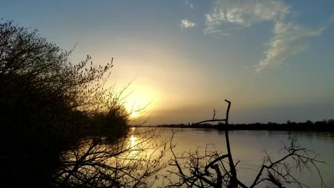 Sunset over a river in springtime	 Stock Footage 273496348