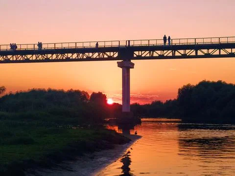 Sunset over the river under the bridge Stock Photos