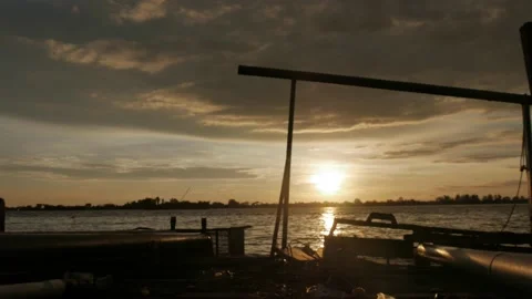 Sunset over the river on water processing station of rubber factory Stock Footage 143563129