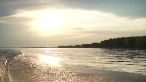 Sunset over river with water wake, motion and tranquil nature landscape Stock Footage 320403080