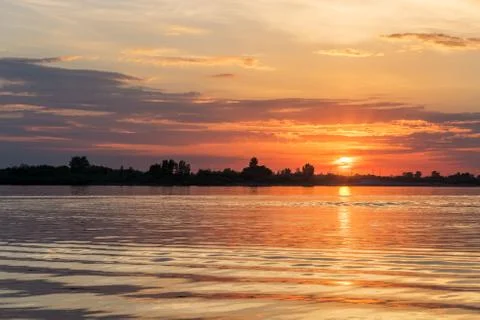 Sunset over river waters Stock Photos