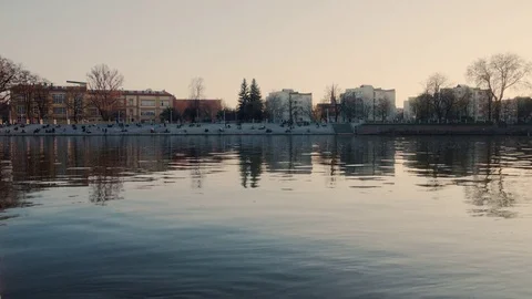 Sunset Over River in Wroclaw, Poland. People Relaxing on Riverside Boulevard 4K Stock Footage