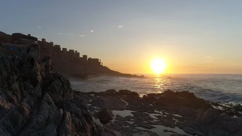 Sunset over rock seashore and ocean, romantic and calm Stock Footage 104888144
