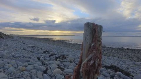 Sunset over a rocky beach Stock Photos