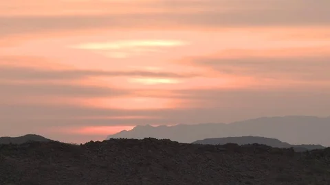 Sunset over rocky mountains in a desert Stock Footage 73661007