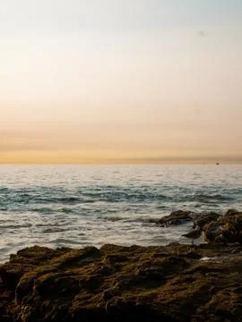 Sunset Over Rocky Ocean Stock Photos