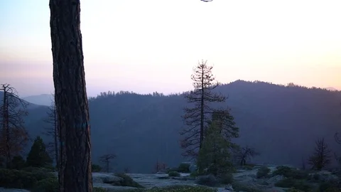 Sunset over rolling hills as a beautiful orange sky fades into the horizon. Stock Footage 119245211