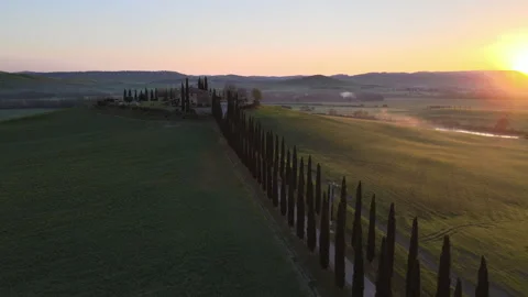 Sunset Over the Rolling Hills of Tuscany, Italy With a Cypress-Lined Driveway Stock Footage 268887703