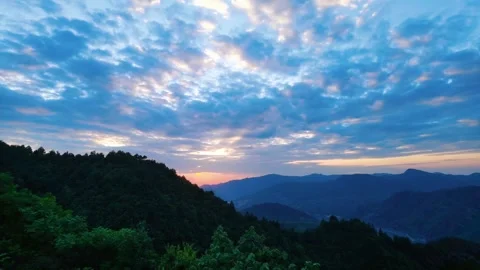 Sunset Over Rolling Mountain Ranges With Vibrant Clouds In The Evening Sky Stock Footage 342017165