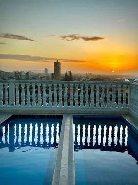 Sunset over rooftop pool Stock Photos