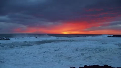 Sunset Over the Rugged Coastline of Iceland with Crashing Waves Stock Footage 320202336