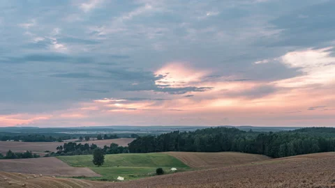 Sunset over rural fields and forests in a countryside timelapse Stock Footage 158945657