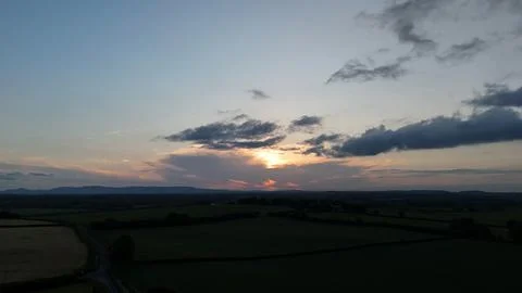 Sunset Over Rural Fields With Cloudy Sky Stock Photos