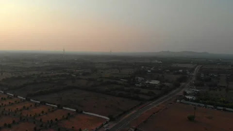 Sunset over rural landscape with wind turbines and farmland Stock Footage 308160128