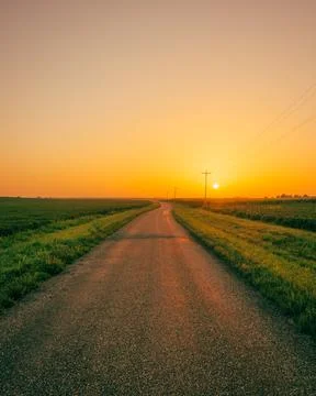 Sunset over a rural road with fields, near Route 66 in Towanda, Illinois Stock Photos
