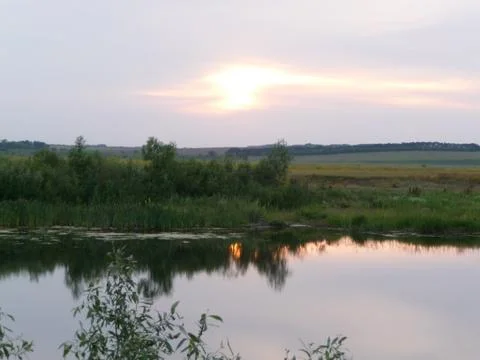 Sunset over the Russian river and forest. Stock Photos