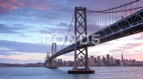 Sunset over San Francisco-Oakland Bay Bridge and San Francisco Skyline. Stock Photos