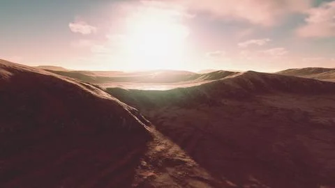 Sunset over the sand dunes in the desert. Aerial view Stock Illustration