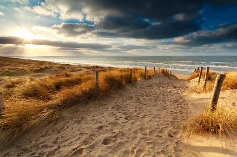 Sunset over sand path to North sea Stock Photos