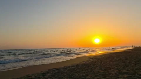 Sunset Over Sandy Beach with Gentle Waves and Calm Evening Sea Stock Footage 341915546