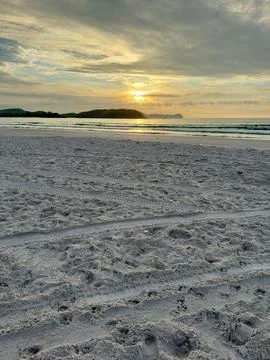Sunset over a sandy beach Stock Photos