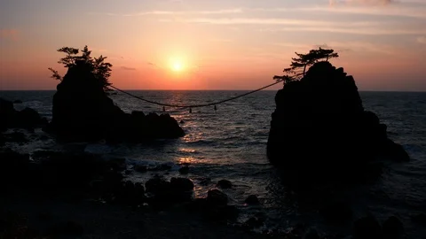 Sunset over Scenic Rocks and a Sea Stock Footage 108384643